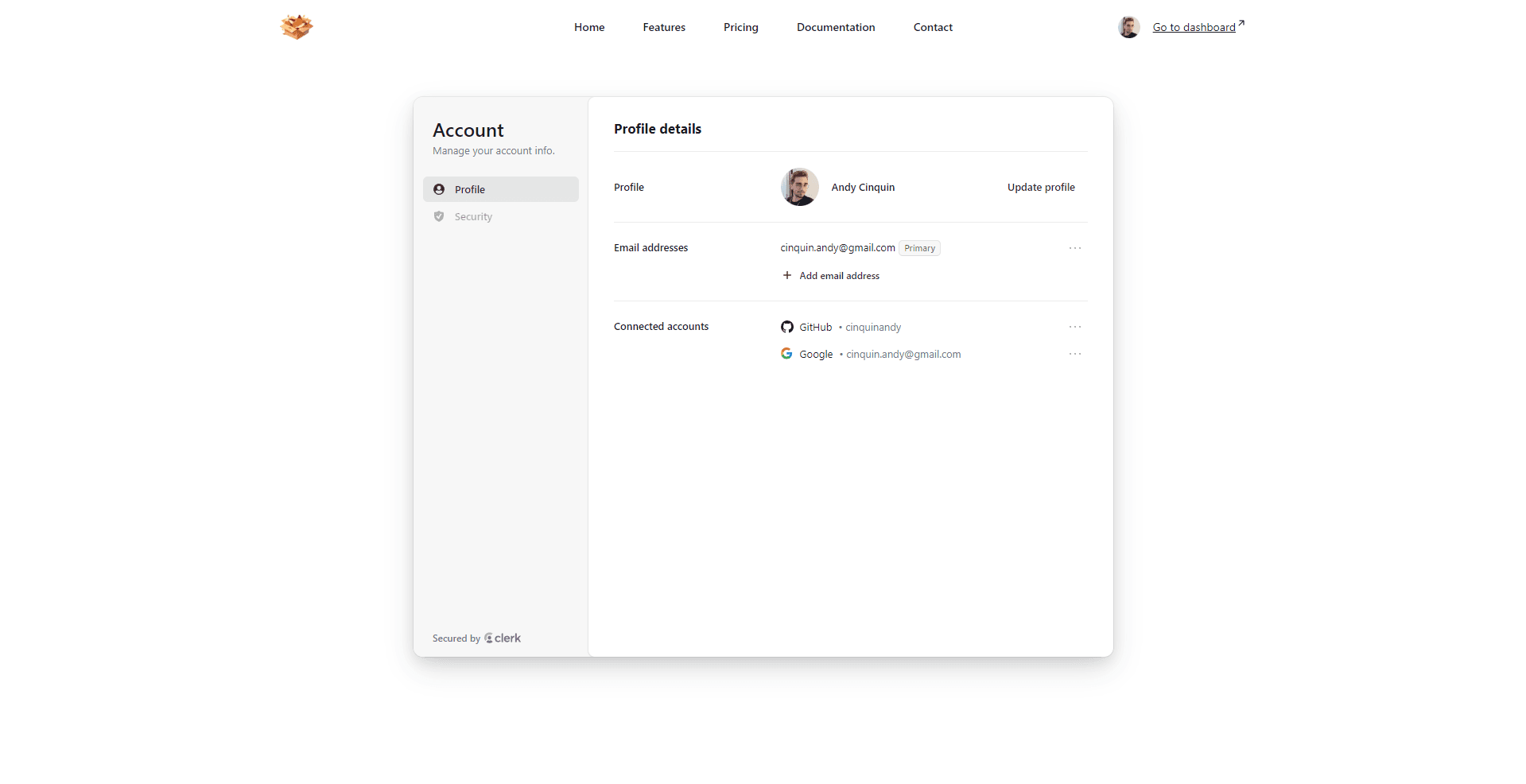 A clean user account management interface on a website with profile details, email addresses, and connected accounts sections.