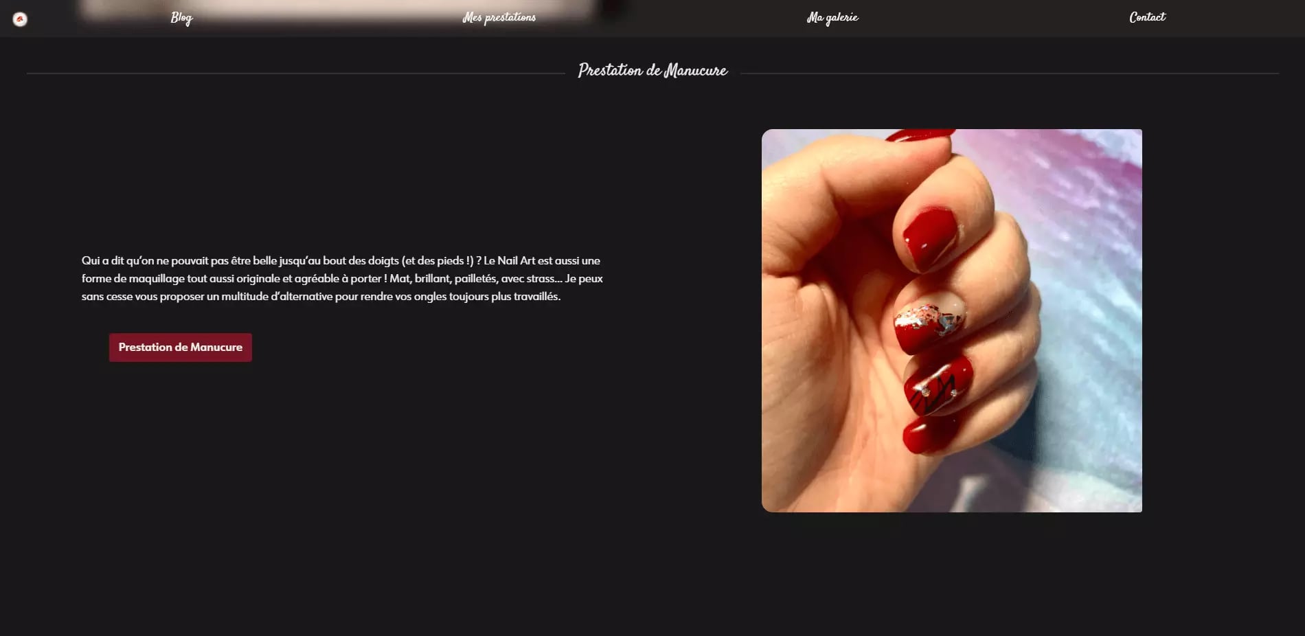 Close-up view of a hand with red manicure and decorative nail art