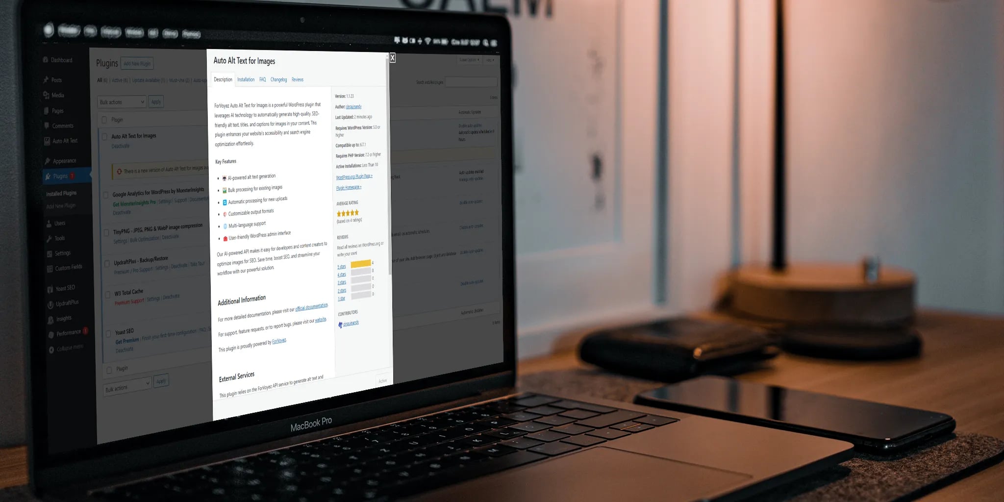 Close-up view of a MacBook Pro displaying the Auto Alt Text for Images WordPress plugin interface, surrounded by devices on a textured surface and warm lighting