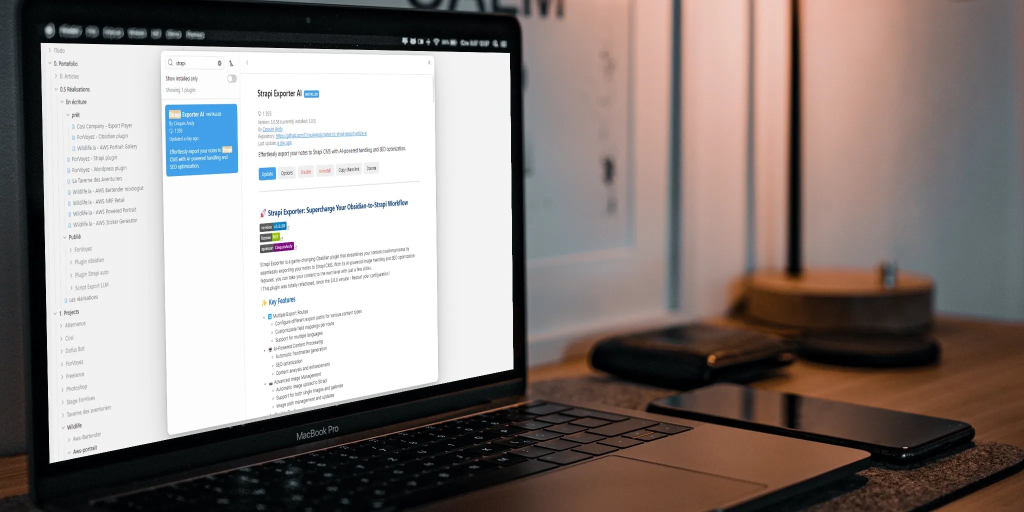 A modern workspace featuring a MacBook Pro with a document about Smagi Exporter, surrounded by electronic devices and a stylish lamp casting a warm glow.