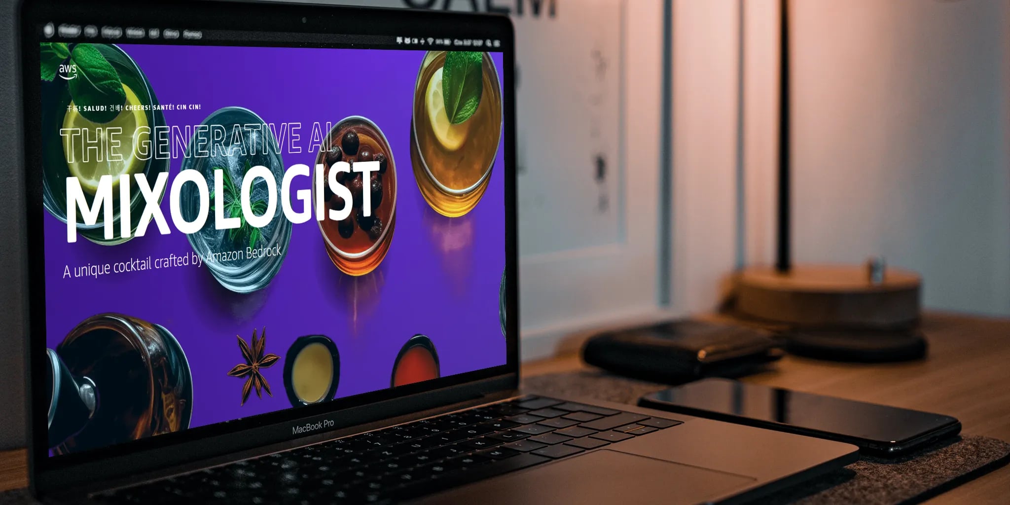 A laptop on a wooden desk displaying a vibrant webpage titled 'THE GENERATIVE AI MIXOLOGIST' with colorful cocktails on a purple background, surrounded by smartphones and a stylish lamp.